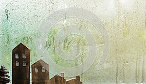 Raindrops on window glass and house sculpture wood background