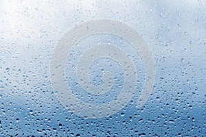 Raindrops on window glass surface, background texture