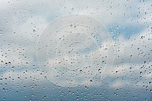 Raindrops on window glass surface, background texture