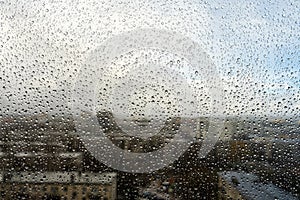 Raindrops on the window. Landscape through the humid glass.