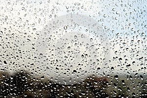 Raindrops on the window. Landscape through the humid glass.