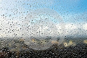 Raindrops on the window. Landscape through the humid glass.