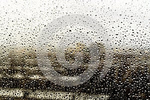 Raindrops on the window. Landscape through the humid glass.