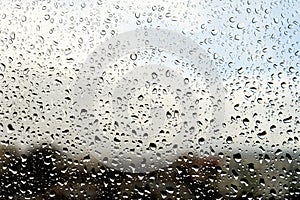 Raindrops on the window. Landscape through the humid glass. photo