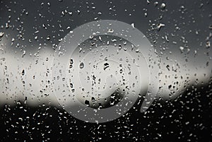 Raindrops on the window pane. Black, gray, white gradient
