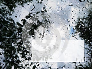Raindrops on the window with text box template. Rainy weather water drops macro