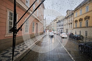 Raindrops on window of tram in city street