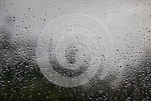 Raindrops on the window - view out the window outwards, rainy weather