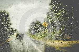Raindrops On a Windshield, Blurred Road Background
