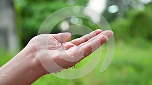 Raining drops of water flowing into the hands hd slow 120 frames