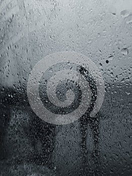 Raining, rain drops in the car mirror