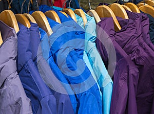 Rainproof jackets on a rack for sale.