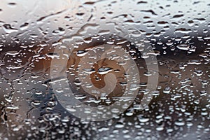 Rainwater makes lovely patterns on glass window in daytime - stock photo