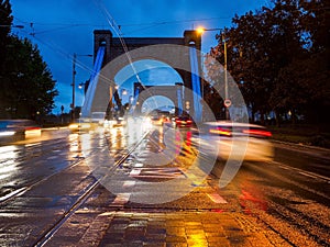 Rainy city street at night, night traffic on wet road during rain