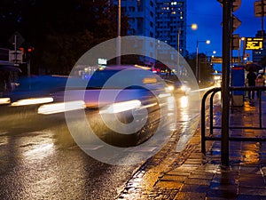 rainy city street at night, night traffic on wet road during rain