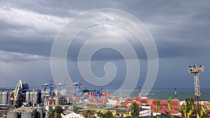 Rainy clouds in sky over industrial port landscape