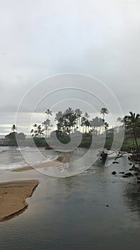 Rainy and cloudy sunrise in October in Wailua Bay near Hikinaakala Heiau on Kauai Island, Hawaii.