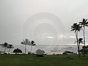 Rainy and Cloudy Sunrise in October in Wailua Bay near Hikinaakala Heiau on Kauai Island, Hawaii.