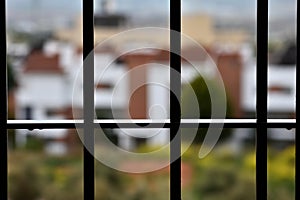 A rainy day behind the window bars at home