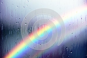 Rainy Day Concept. Rainbow as Outside. Water Droplet Texture Background, Rain Drops on Glass Window