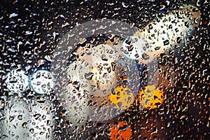 Rainy day, rain drops on window, rainy weather, rain and traffic lights bokeh, traffic jam, defocused