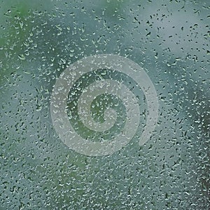 Rainy day, raindrops on wet window glass, vertical bright abstract rain water background pattern detail, macro closeup, detailed