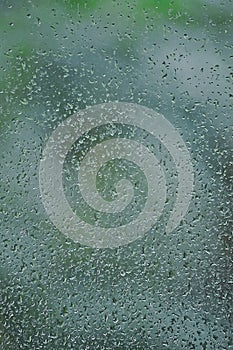 Rainy day, raindrops on wet window glass, vertical bright