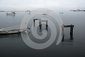 Rainy day in Umag port, Croatia with moored boats in depressive gray sad mood