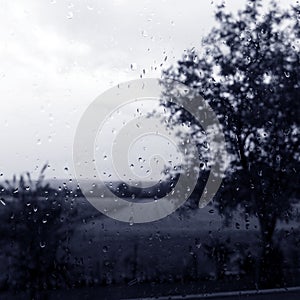 Rainy day window with field countryside view