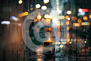 Rainy evening city view,car traffic light, from window people walk  , candle light reflection rain drops on glass urban