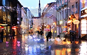 Rainy evening Tallinn  old town  people walking  on wet street with umbrellas blurred light tourist  urban city lifestyle