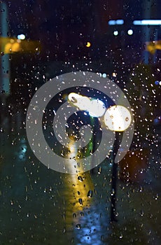 Rainy evening with water drops on the glass photo