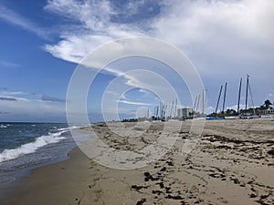 rainy overcast sunset on the beach and sailboats