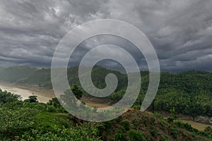 During the rainy season, the thick green hills blend into the thick black clouds in the sky. Sangu river flows below. Hilly region