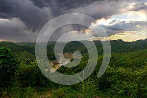 During the rainy season, the thick green hills blend into the thick black clouds in the sky. Sangu river flows below. Hilly region