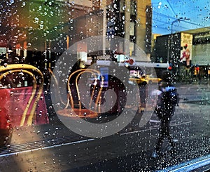 Rainy street people walk cafe table and chair in window vitrines reflection city lifestyle  Autumn season