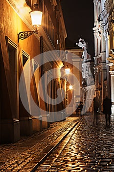 Rainy walk the cobbled street at night