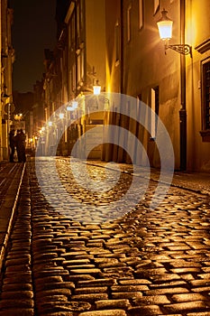 Rainy walk the cobbled street at night