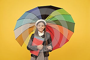 rainy weather forecast. back to school. vivid rain protection. happy girl in glasses hold notebook