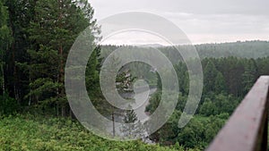 Rainy weather in forest area with mountain river. Stock footage. Beautiful landscape with torrential rain over