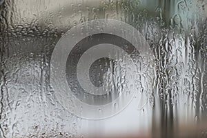 Rainy weather, raindrops on the glass of window, water drips wet. Texture, background