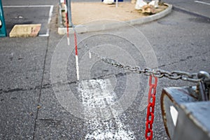 Raised chains at the entrance to the parking area