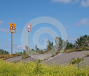 Raised coastal road along the ribble estuary near southport merseyside with turning and speed limit traffic signs