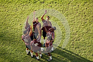 Raised hand, sports and rugby people celebrate teamwork, team building or winning game, match or tournament competition