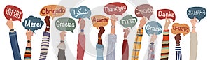 Raised hands of people holding speech bubbles with text -thank you- in international languages . Banner