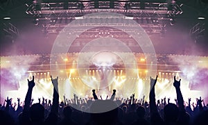 Raised hands silhouettes during a concert