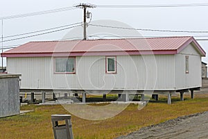 Raised House in the Arctic over the Permafrost photo