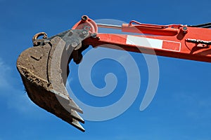 Raised scoop of an earth mover