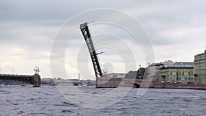 Raised span of bascule Trinity bridge, panoramic side view from water.