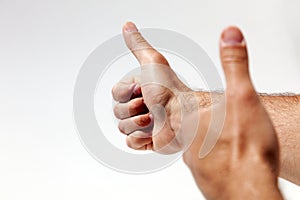 Raised thumbs isolated on a white background. Symbol of success